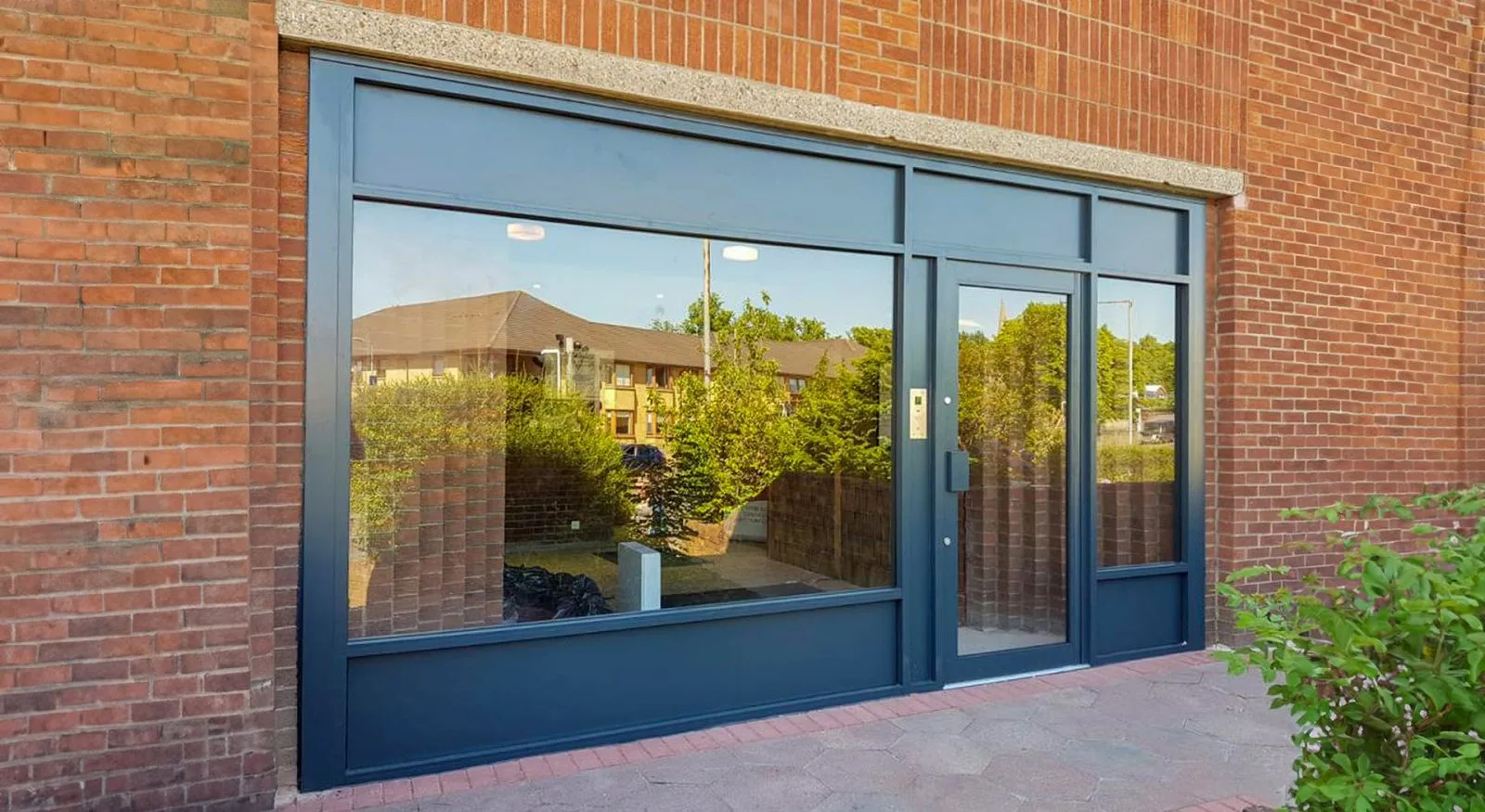 Aluminium-framed shop front on a brick commercial building