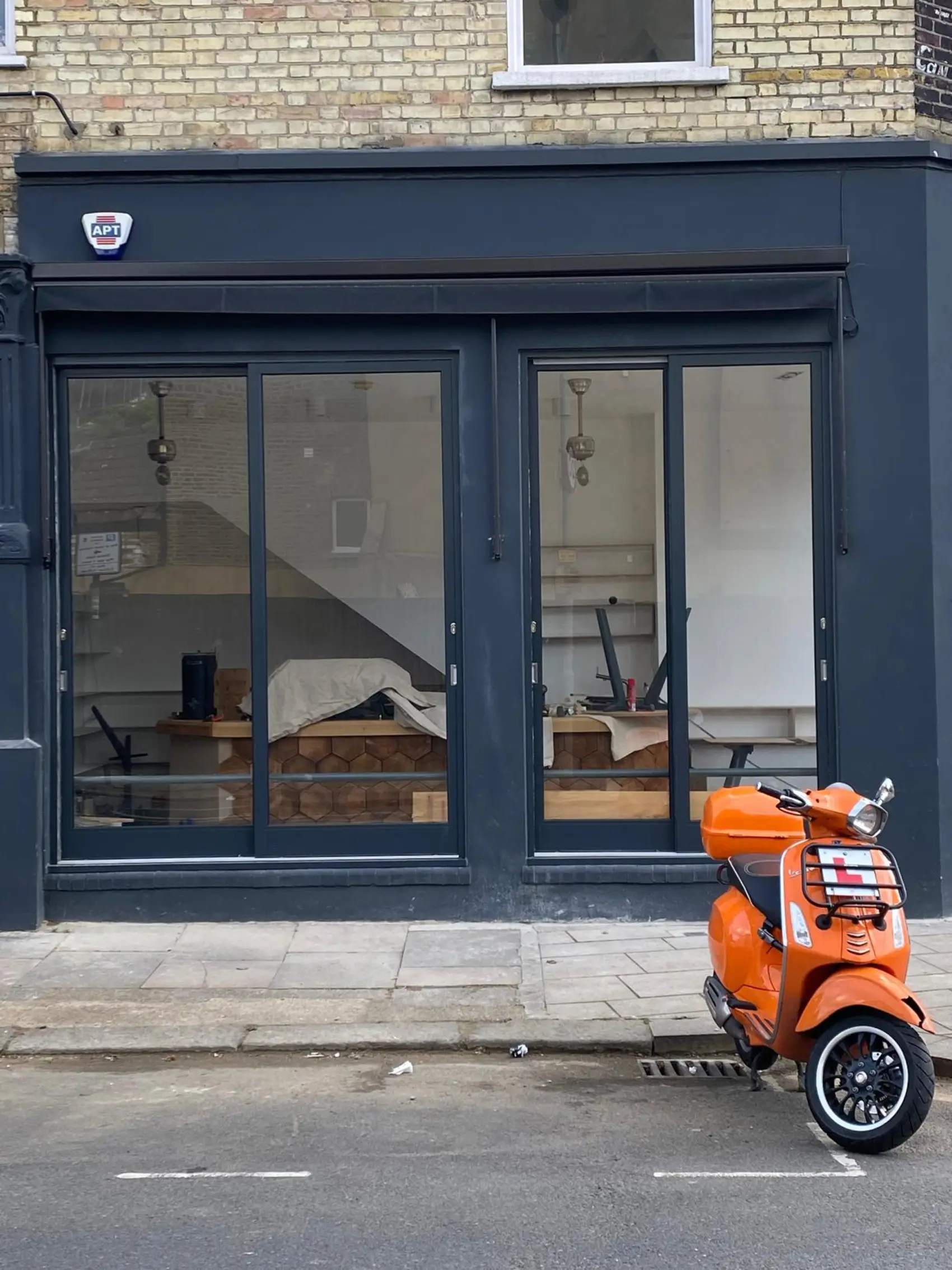Anthracite aluminium shopfront with glazed commercial doors installed in London by Range Shop Fronts