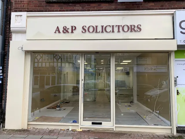 White aluminium shopfront with sliding doors fitted for A & P Solicitors