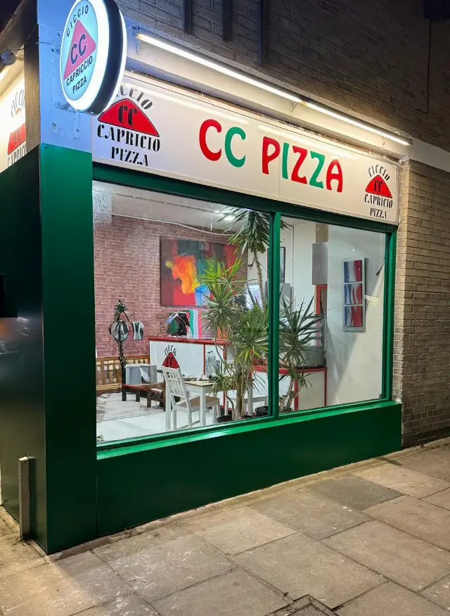 Green takeaway shopfront with display window for CC Pizza