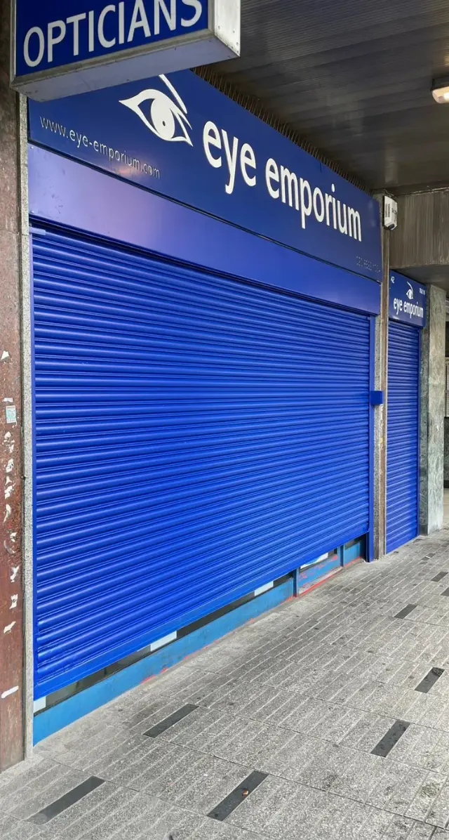 Blue solid roller shutter for Eye Emporium opticians