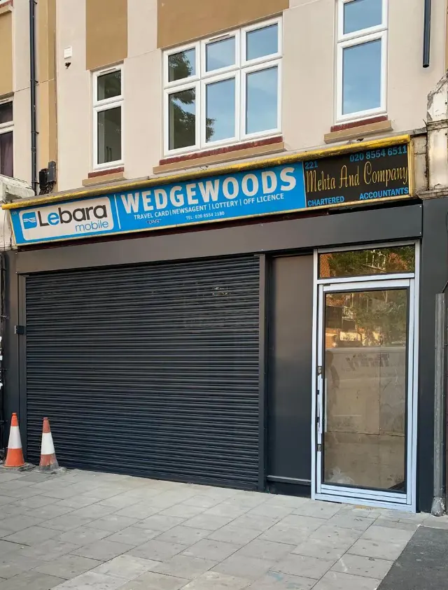 Black roller shutter and entrance door for Lebara Mobile at Wedgewoods