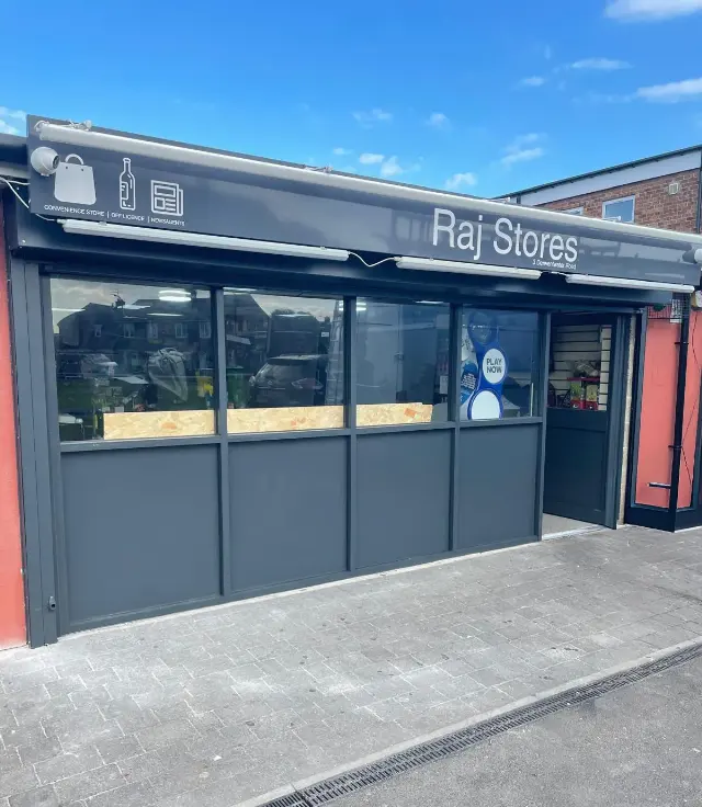 Grey aluminium shopfront installed for Raj Stores