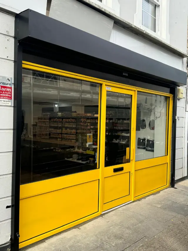 Yellow aluminium framed storefront with display glazing