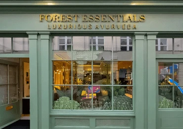 Traditional timber shop front with glazing bars painted sage green