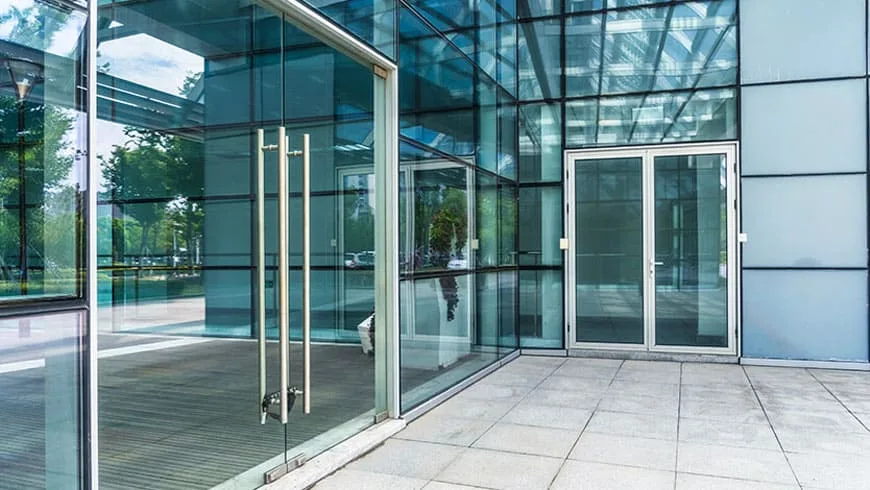 Frameless glass double doors at a commercial entrance