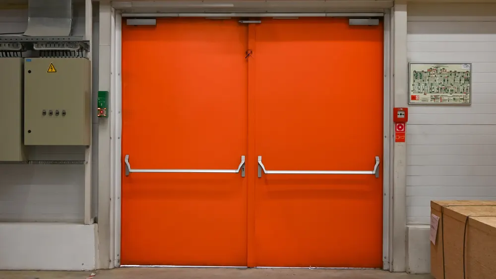 Steel fire-escape double doors with push-bar panic hardware